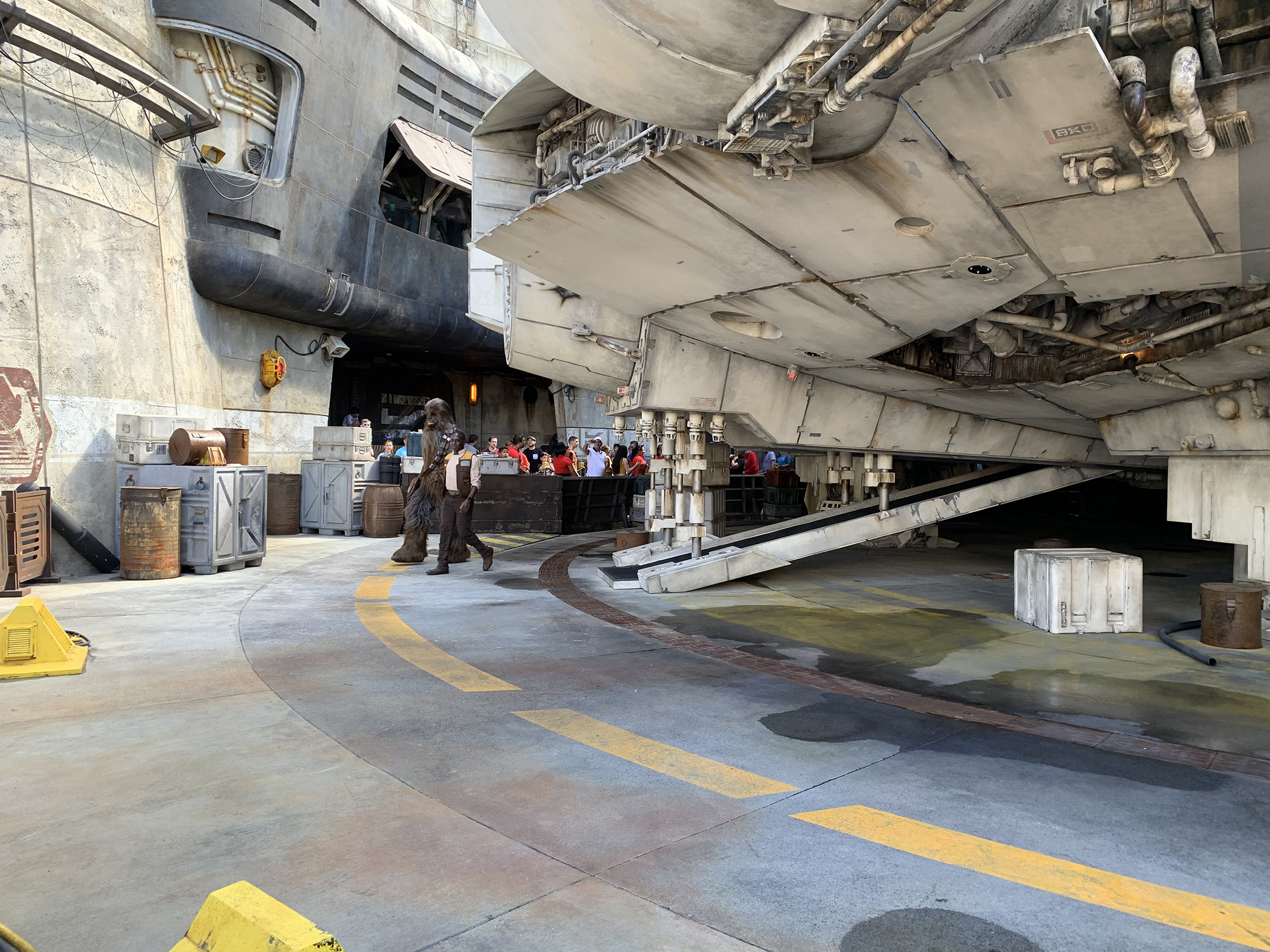 Chewbacca walking under Millennium Falcon