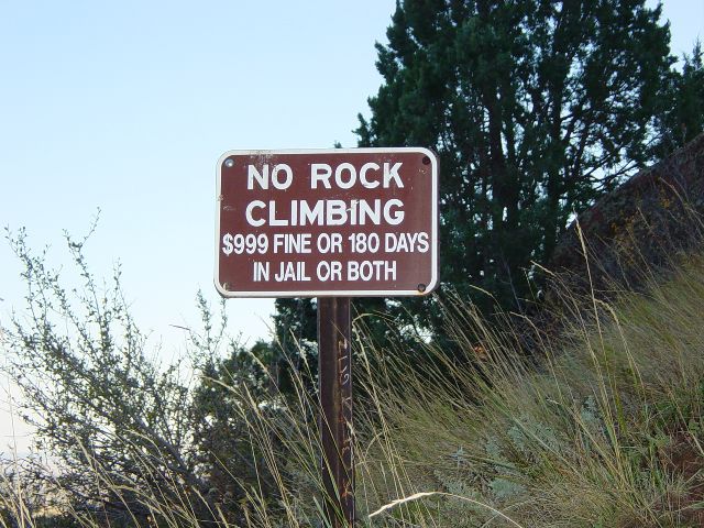 Sign warning of dangers of climbing on rocks