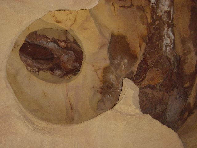 indentations in cave ceiling that resemble a footprint