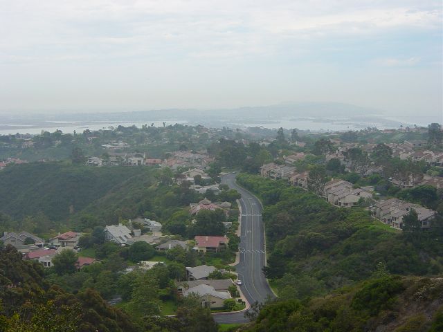 Hills with houses falling away to the ocean