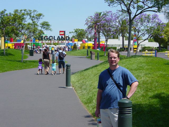 James with theme park entry gates in background