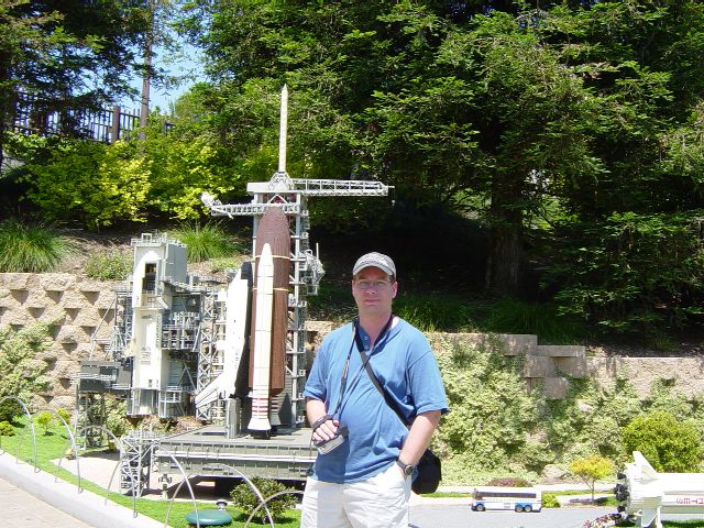 James next to LEGO model of Space Shuttle on launch pad