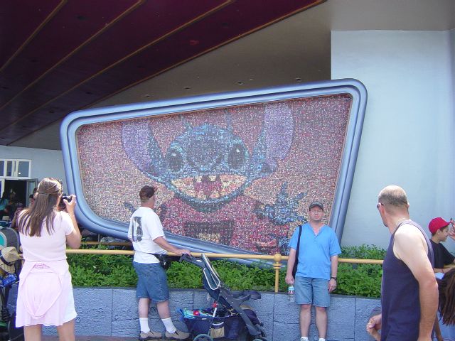 James next to a photomosaic of Disney's Stitch character