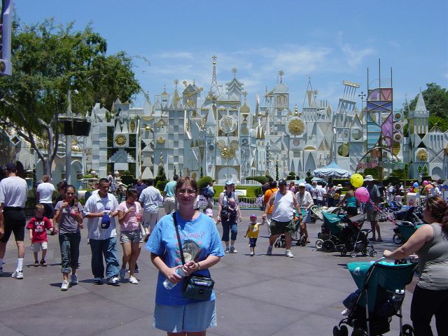 Julie standing in front of a white and gold facade