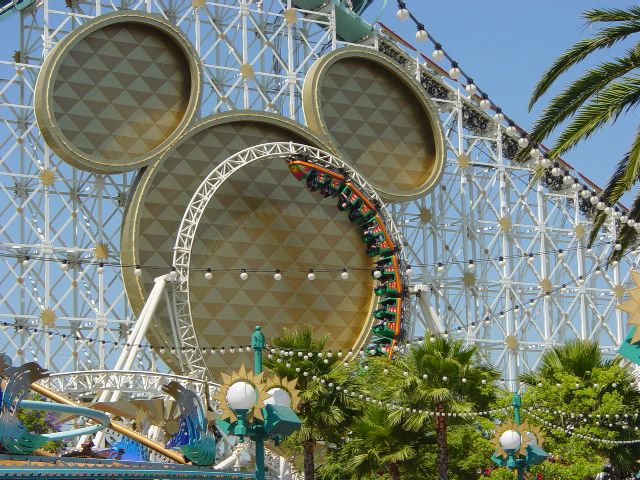 Rollar coaster going through loop in front of Mickey head ornament