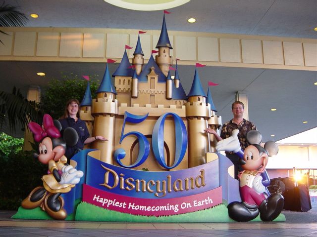 James and Julie on either side of 50 year celebration sign