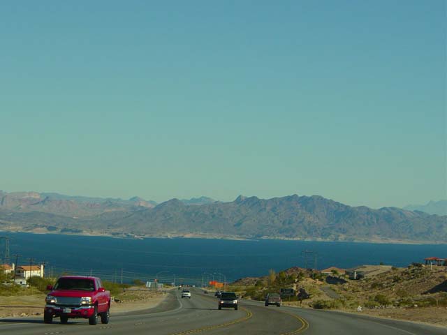 Blue water lake surrounded by dusky brown hills