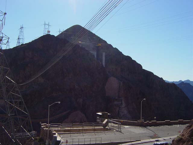 A crane works among power lines in the mountains