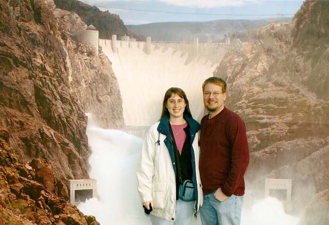 James and Julie in front of a backdroup showing hoover dam and spillways