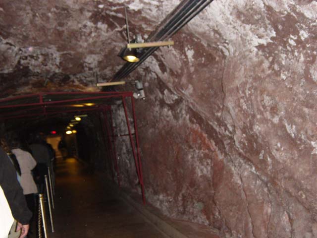 tour group passing through rough hewn caves