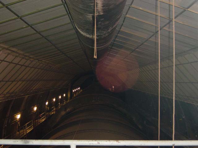 Dark tunnel with metal tubing running through it