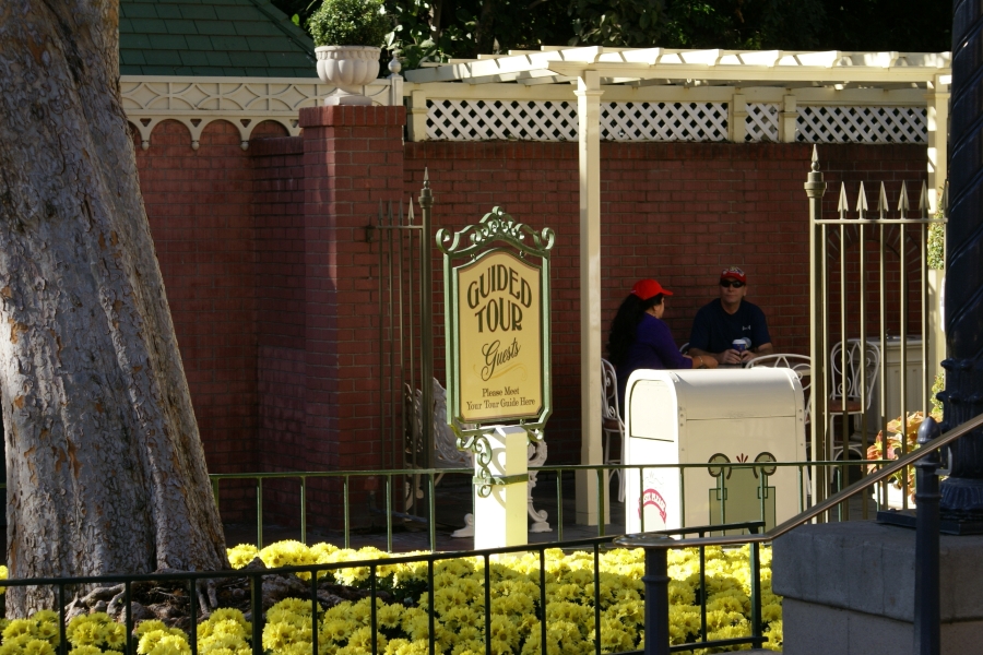 An old sign on a post reads Guided Tour Guests in a stylish script