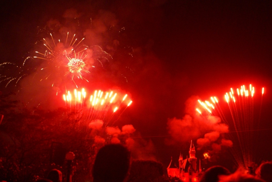 Bright red fireworks light up the crowd