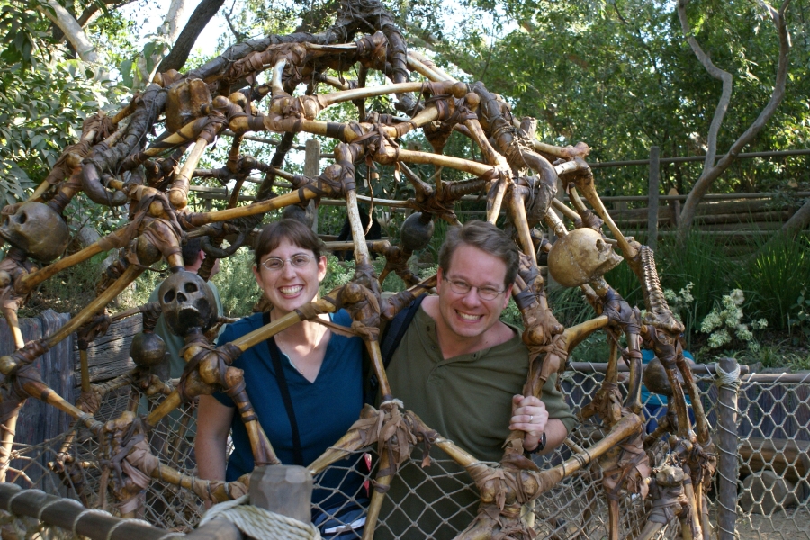Julie and James in a round cage of what looks like human leg bones