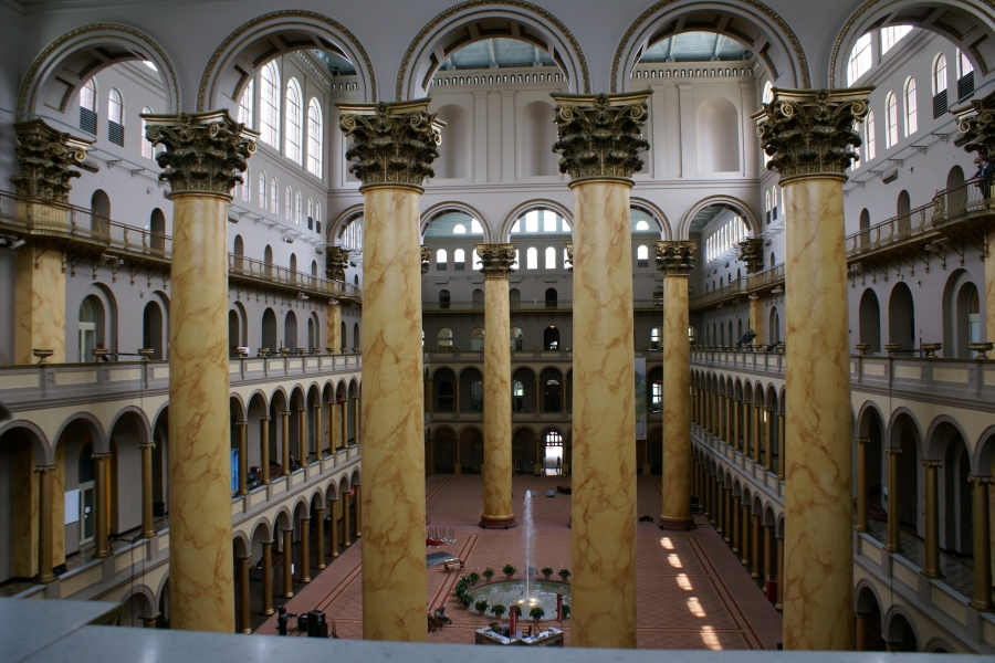 Two rows of six massive yellow marble columns support the roof 4 stories above a large enclosed atrium