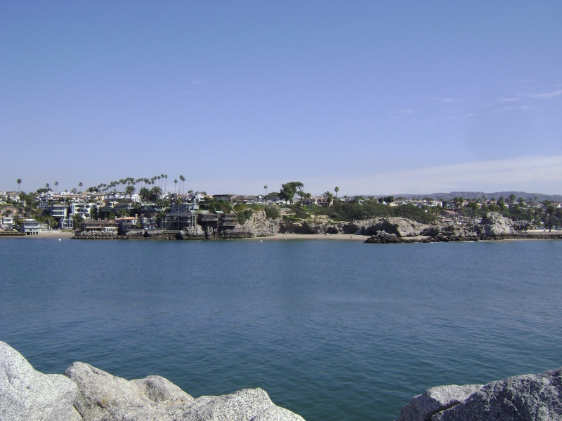 Larger buildings built on or into stoney cliffs coming out of the water