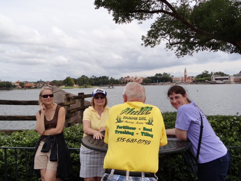 Jim looks away from the camera showing off his Huitt Farms shirt while Julie, Cheri, and Gayle look on