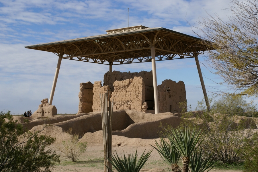 Four poles support an open web framed canopy above 30-foot-tall weather adobe walls