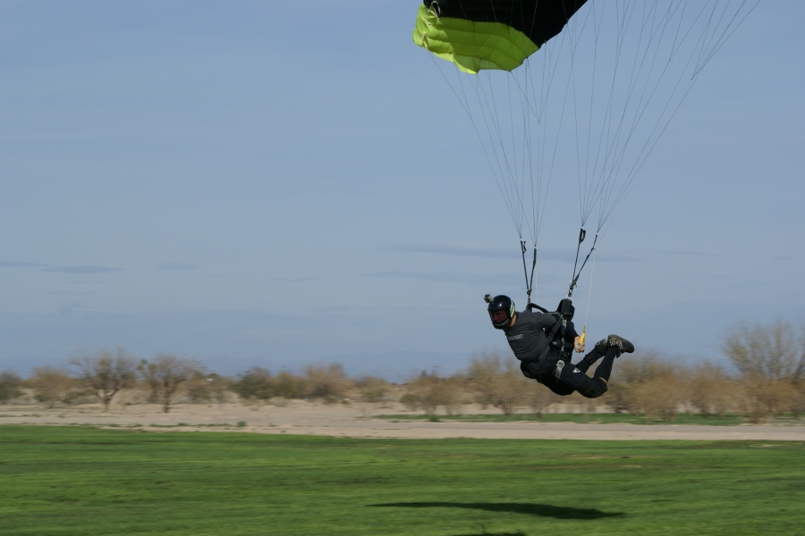 A jumper is leaning forward with their feet out behind them gliding only 6 feet off the ground