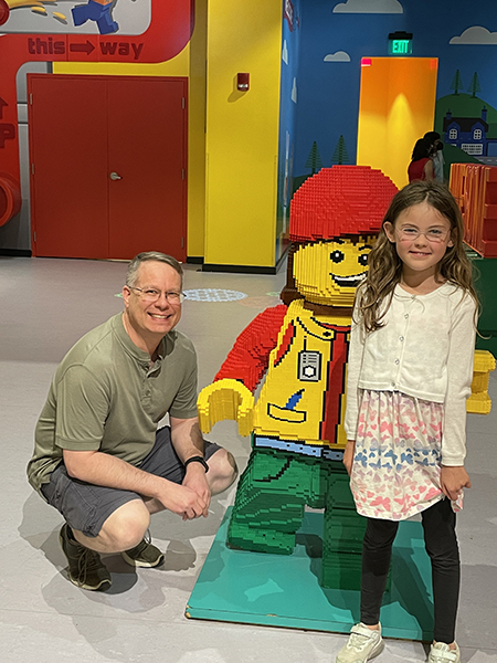 James and Arden next to a three-foot-tall LEGO minifigure