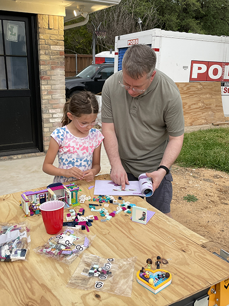 James and Arden work on a LEGO set outside