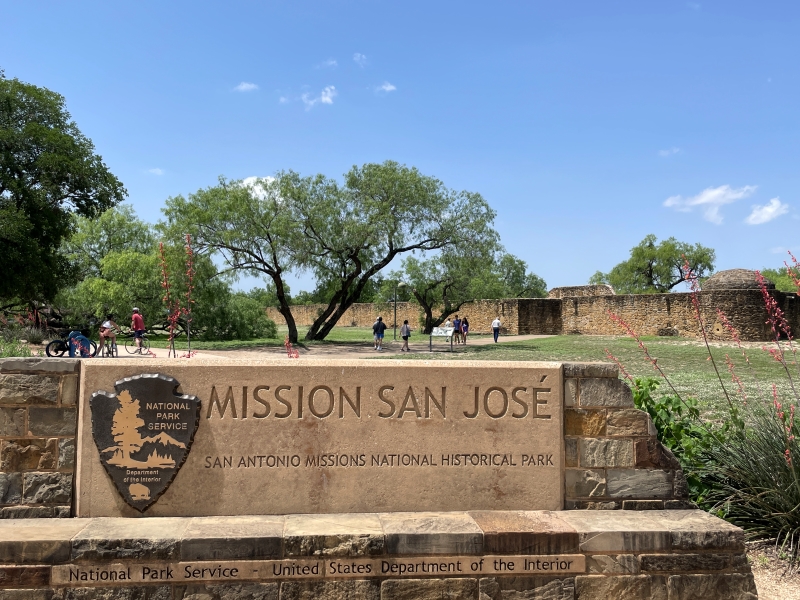 A sign with the National Parks logo reads Mission San José
