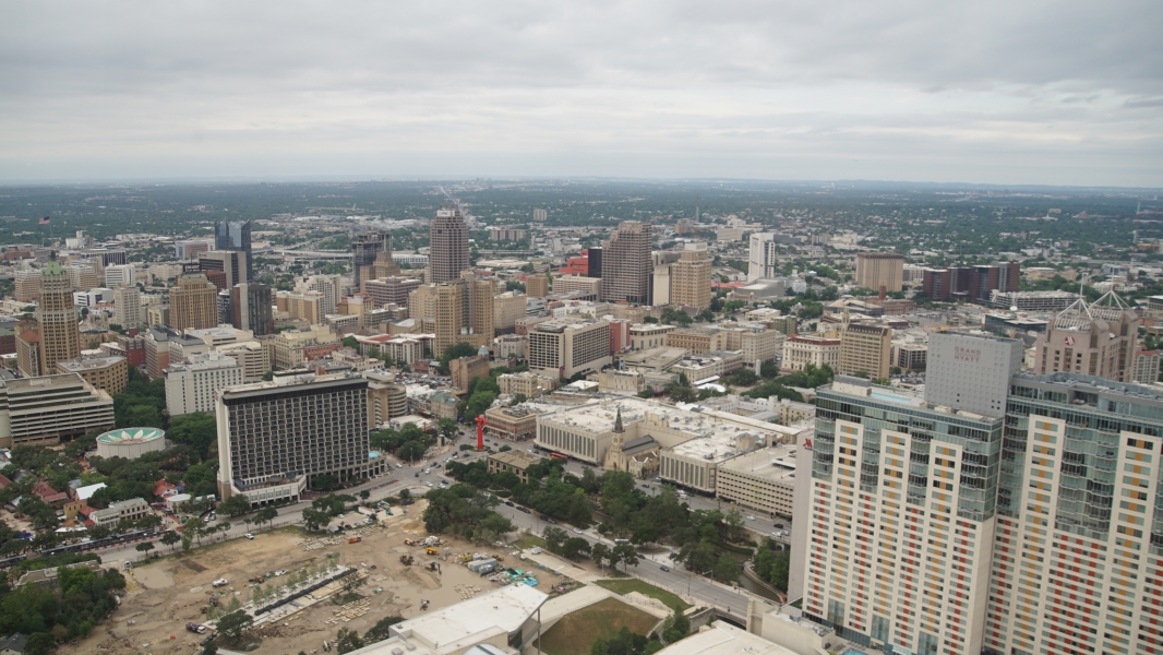 Looking out and slightly down onto a skyline of various height buildings
