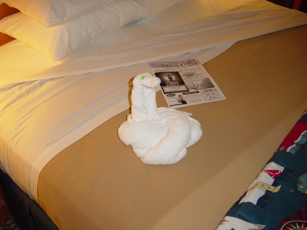 Towels folded into the form of a snake with green stickers for eyes