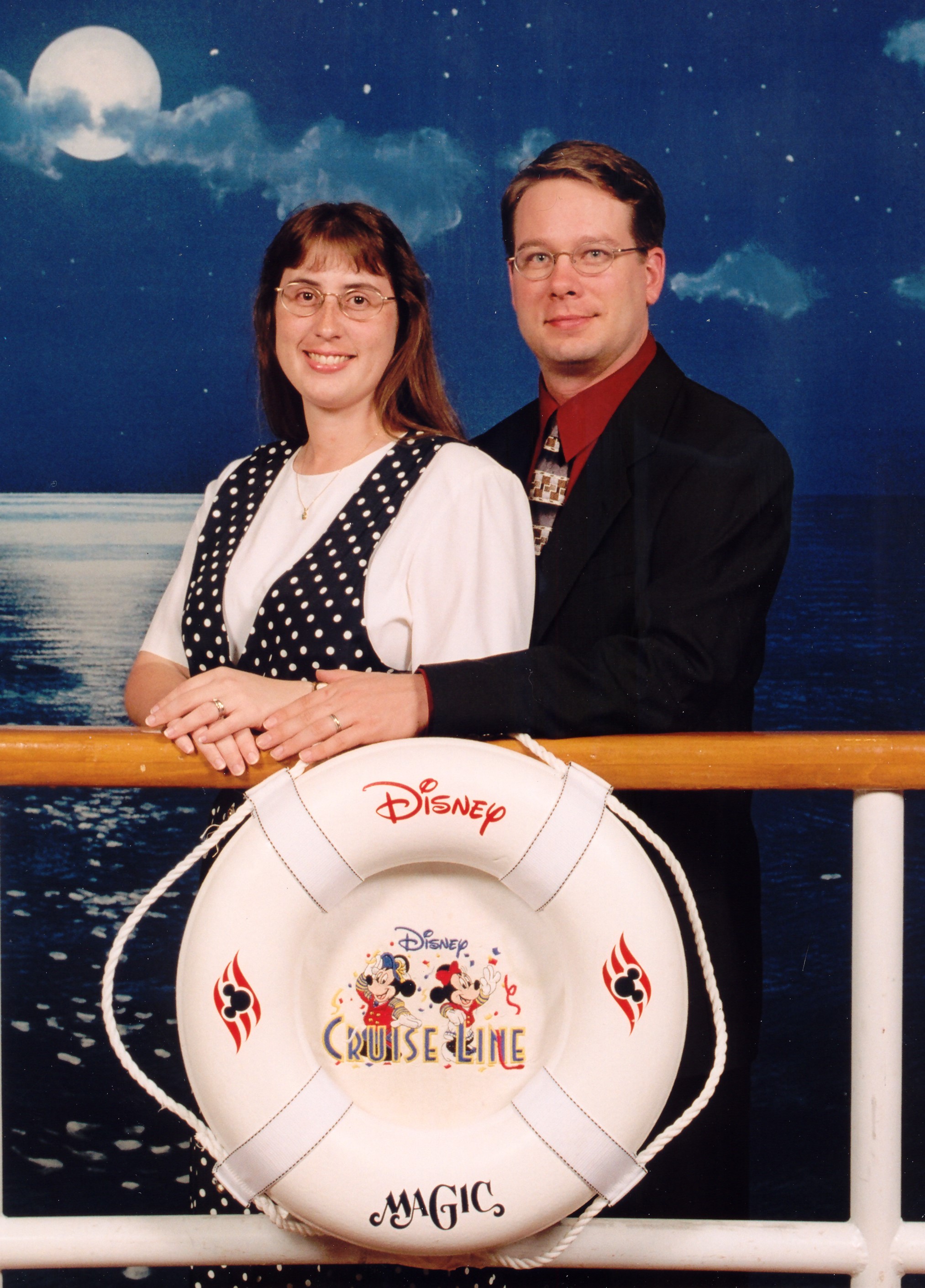 Julie and James dressed up behind the ship's rail
