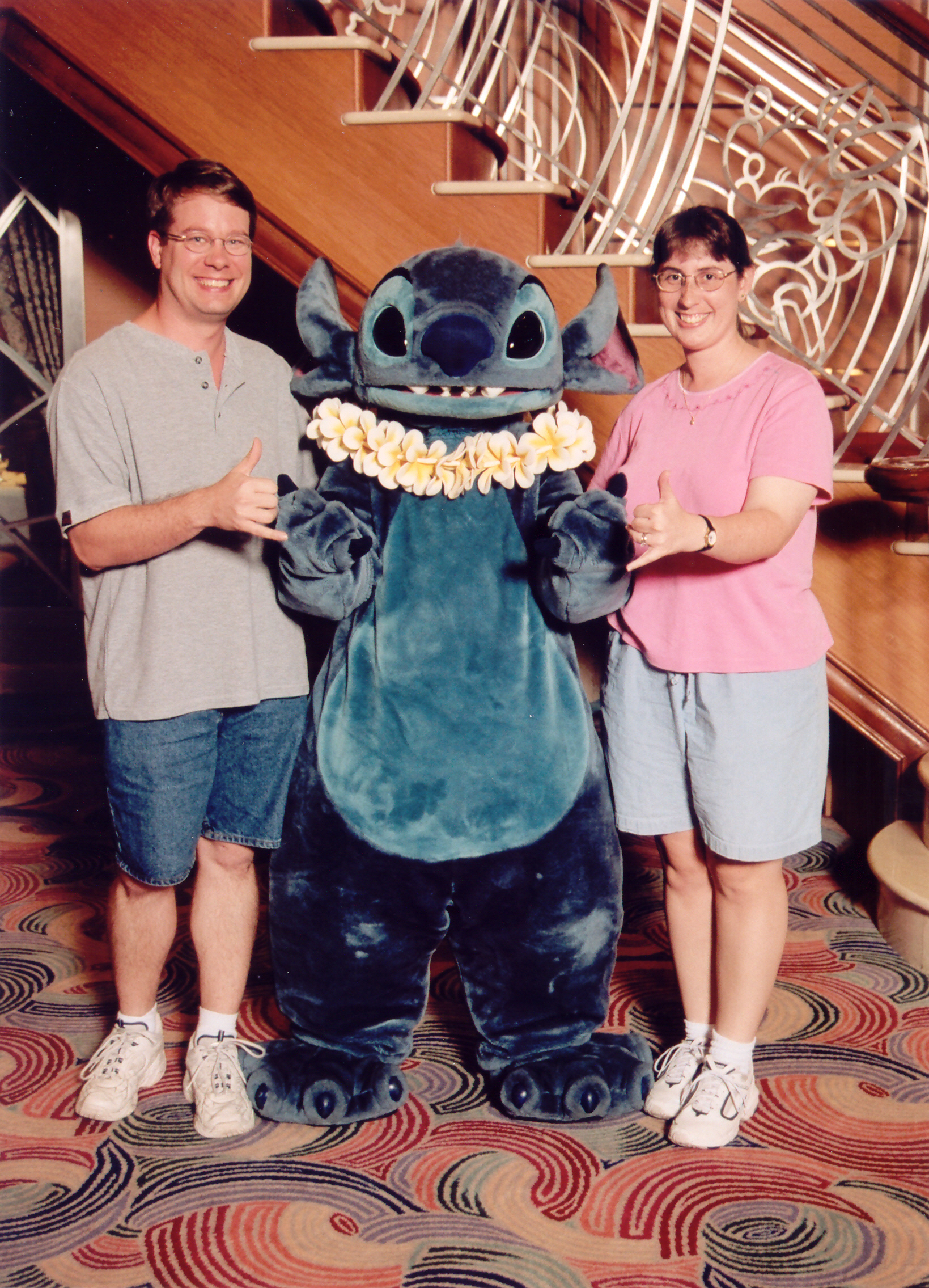Julie and James standing with Stitch