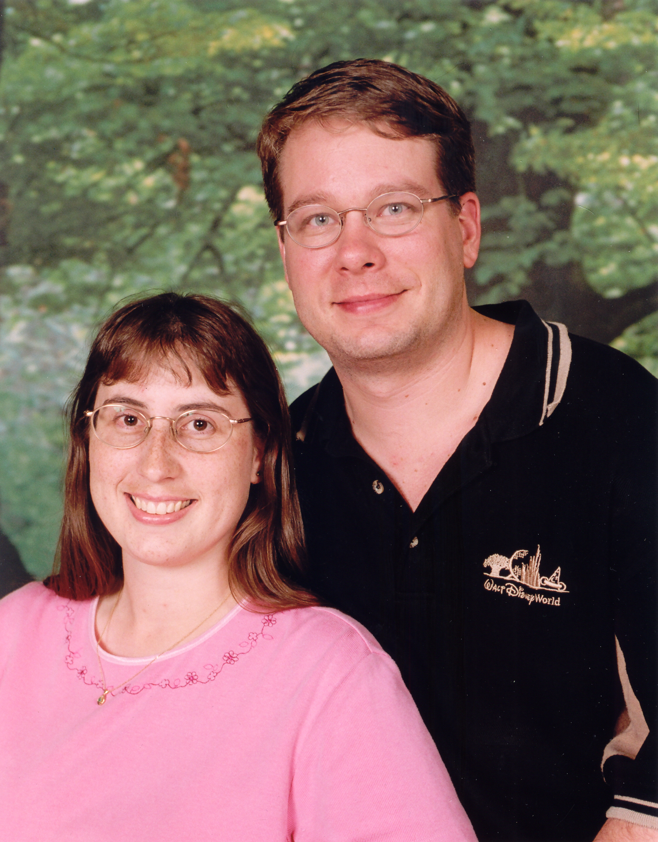 James and Julie in front of a green leafy backdrop