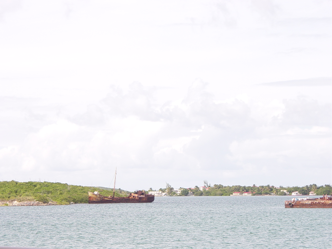 Large boat run aground on scrub brush covered island