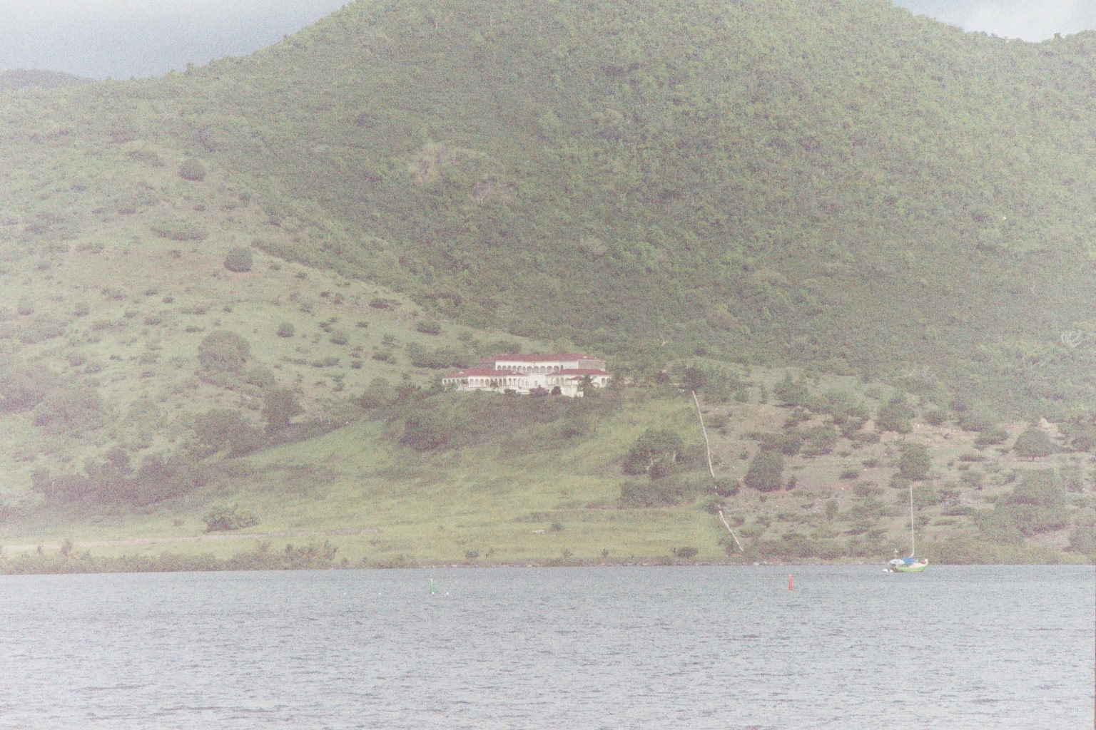 Large mediteranian style villa sits alone on a green hill