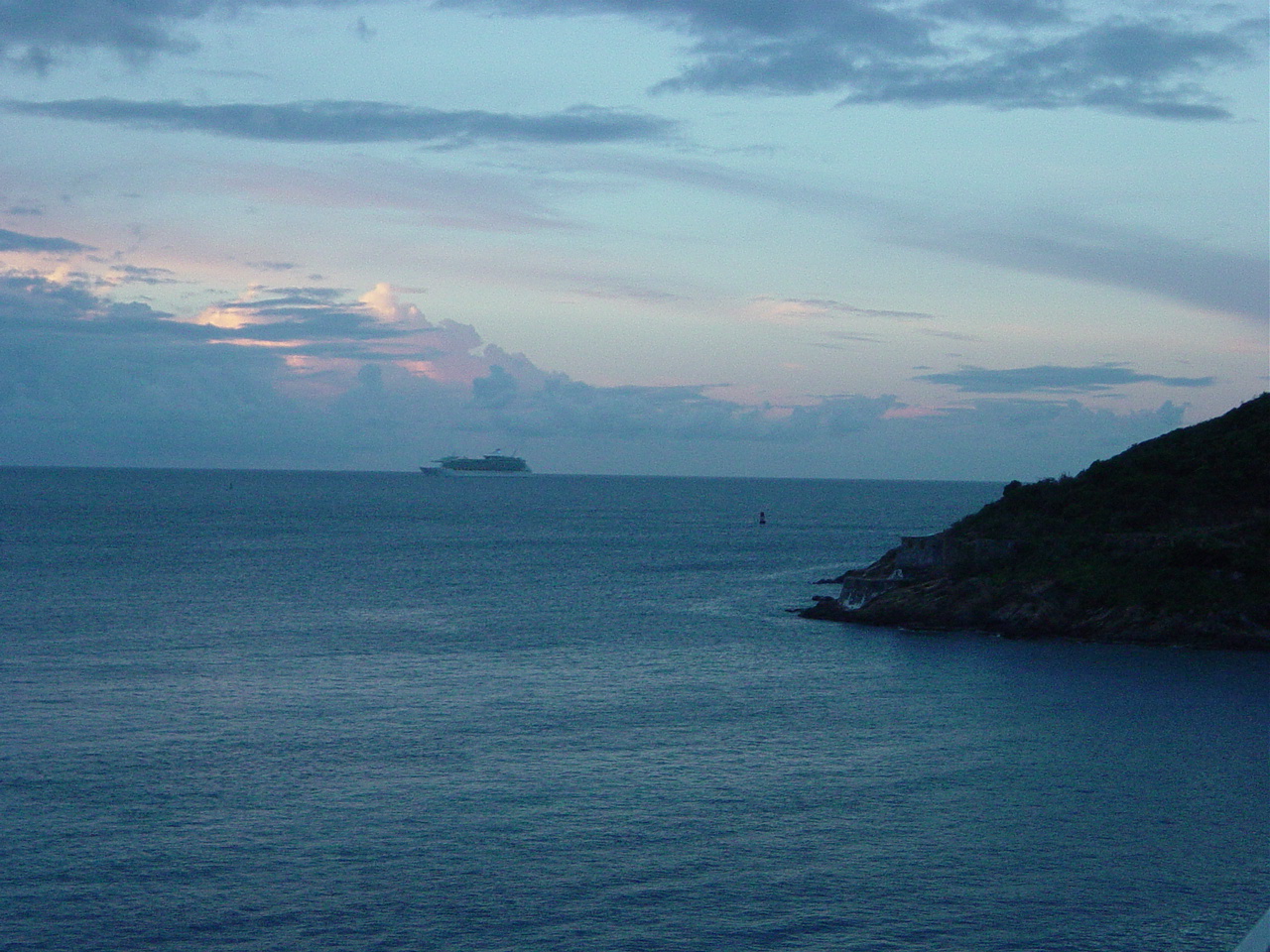 Cruise ship sitting in the water at a distance