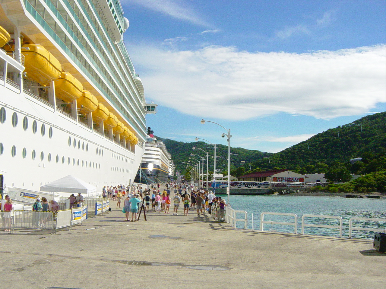 Multiple cruise ships lighed up along the same dock