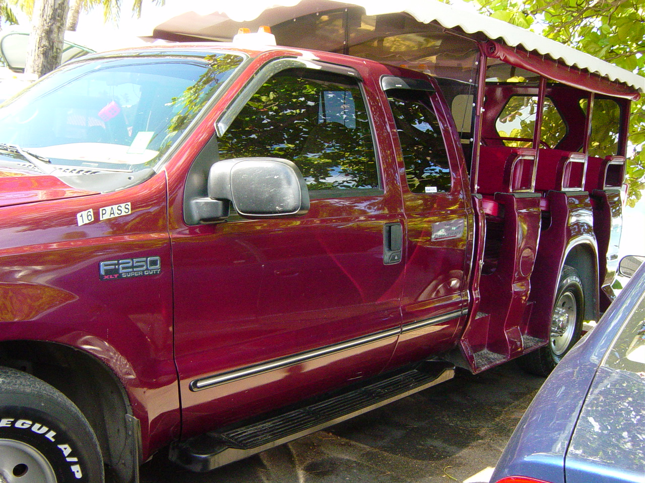 Bright fuscia F250 with seating where the bed should be
