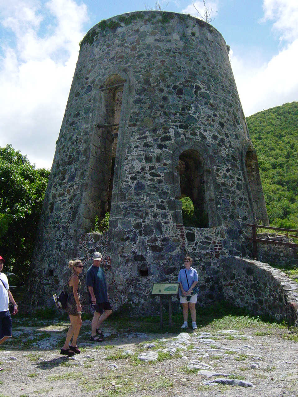 Old round stone structure with large arched windows