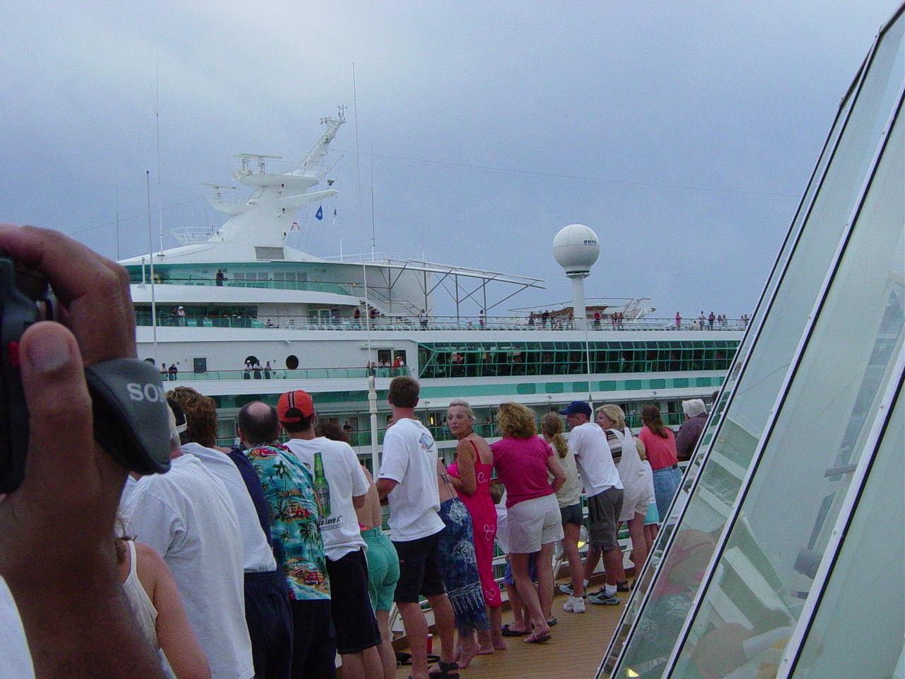 People line the railing as we move past another cruise ship