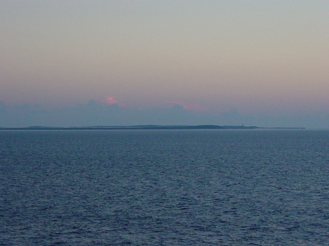Flat island above the water in the hazy morning light