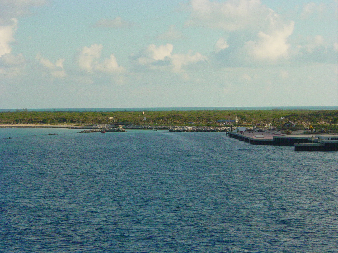 Dock, breakwater and white sand beach visible from veranda