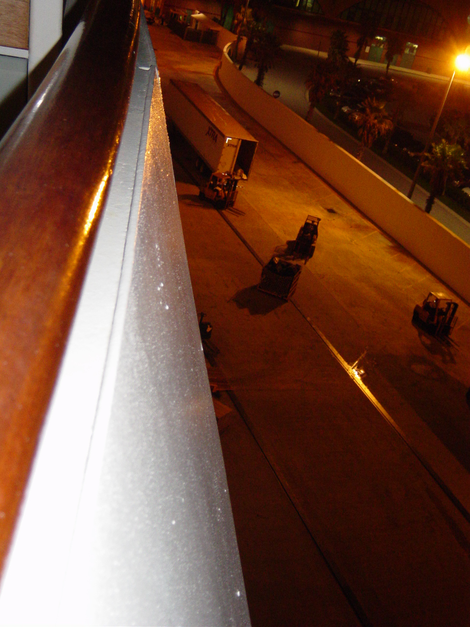 Trucks and fork lifts move under the lights on the dock