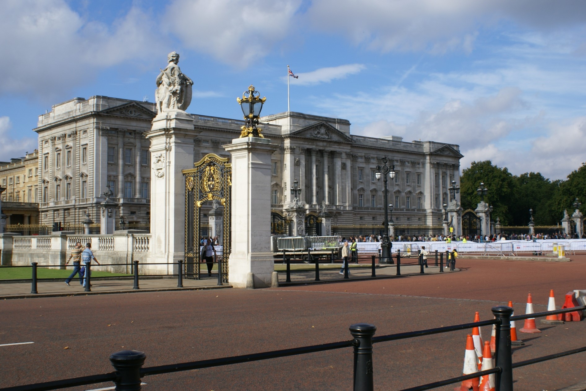 A white Romanesque building behind a wrought iron fence