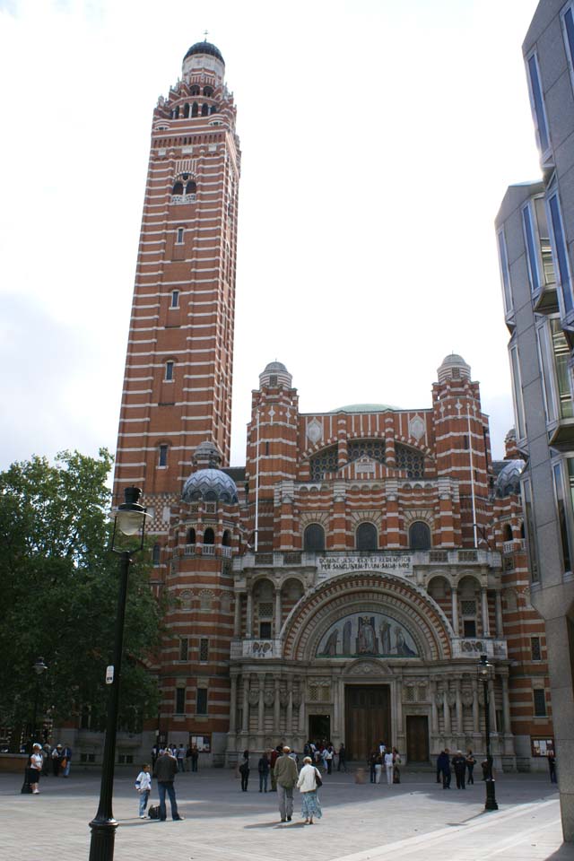 Orange red brick and stone church with an eight-story bell tower