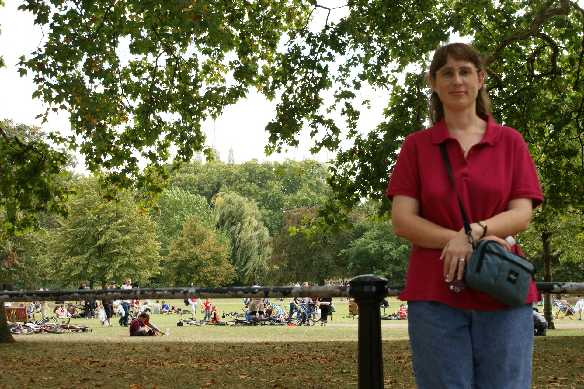 Julie in front of a lawn full of bikers resting after their ride