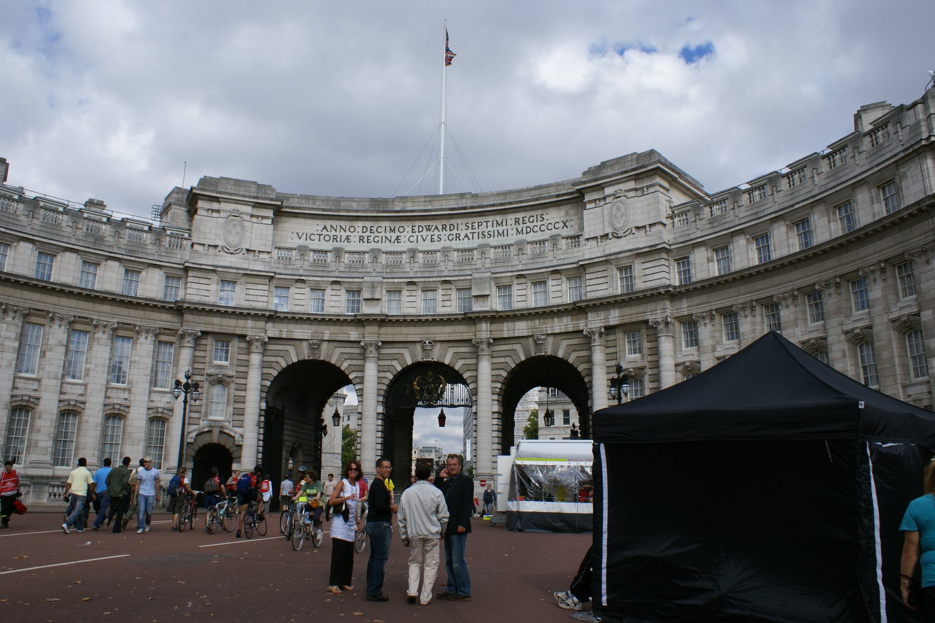 Curved white four-story façade with three large arches