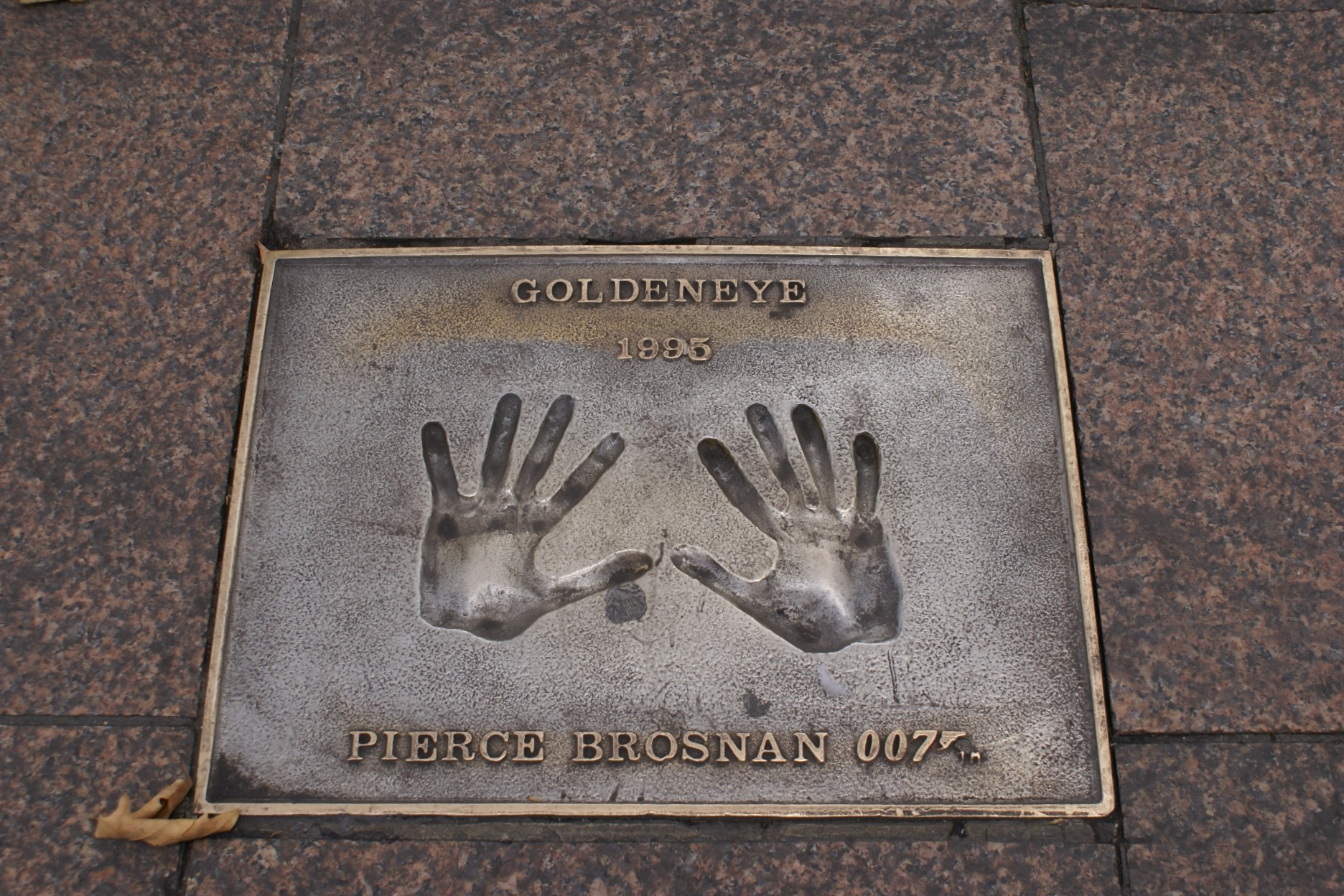 Hands cast in bronze embedded in sidewalk