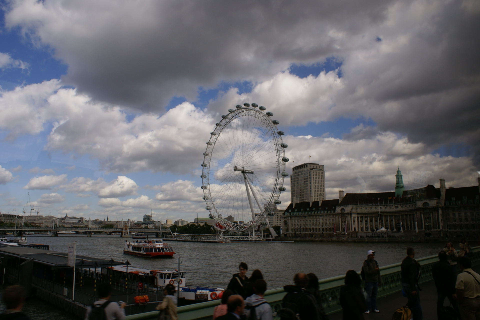 A very large Ferris wheel next to a river