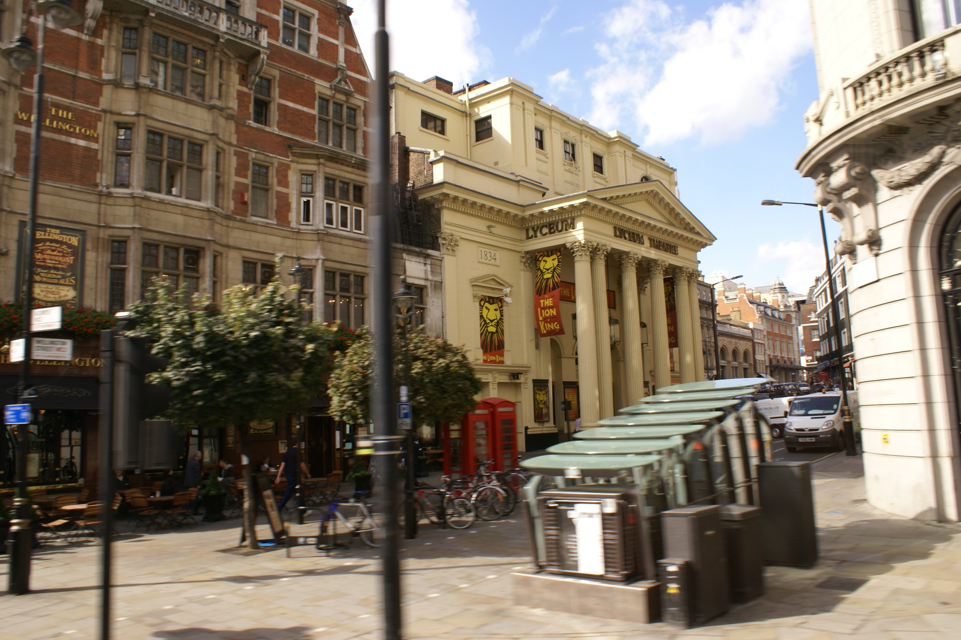 Light tan stone theater building with Lion King banners