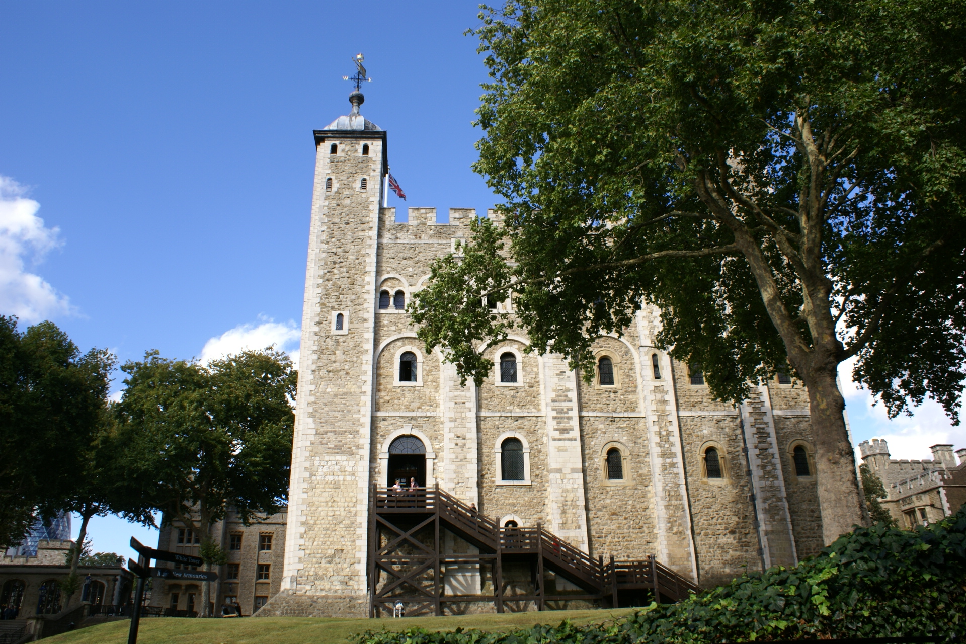 Large white stone structure with a tall tower on one corner