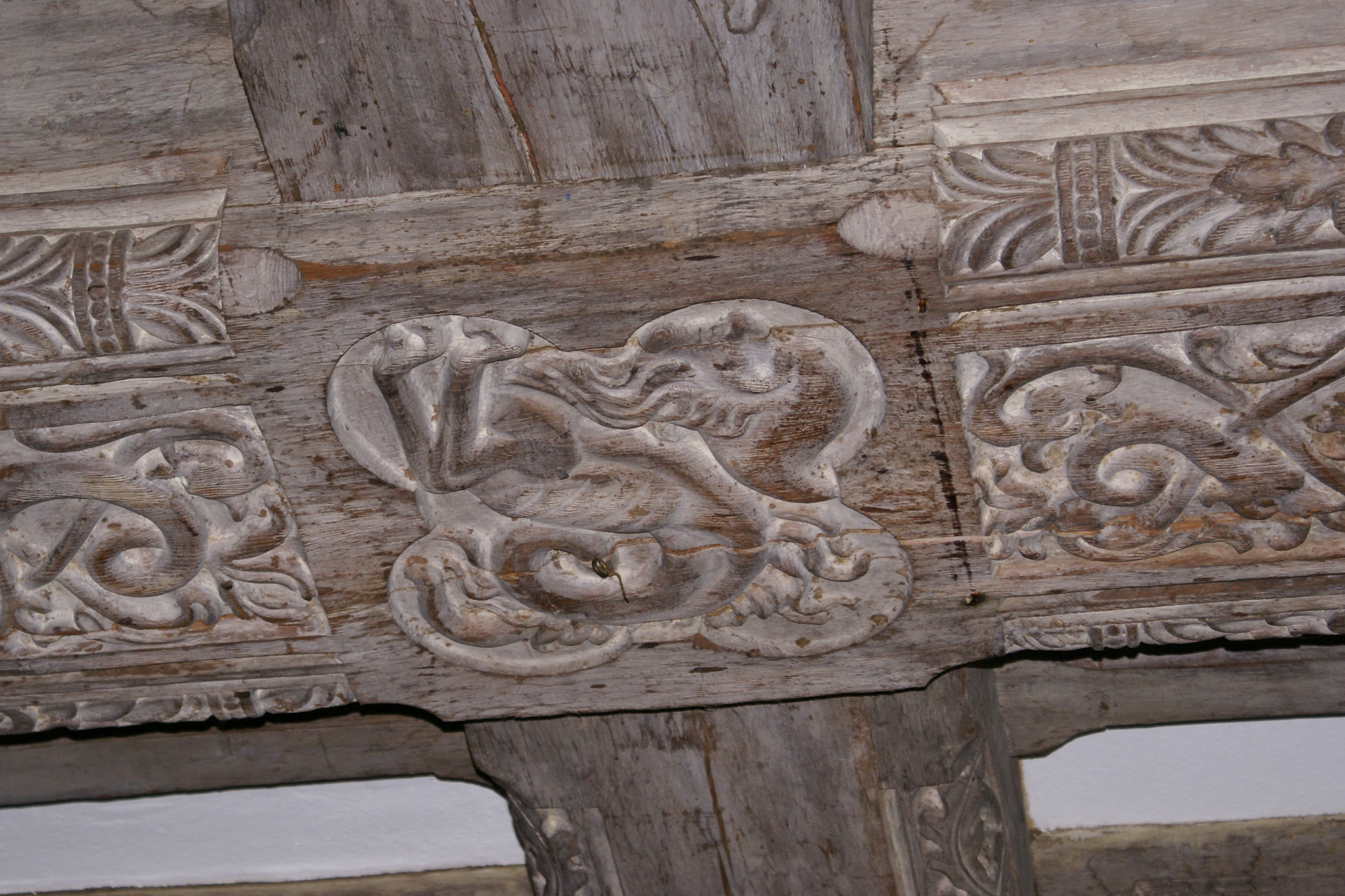 Carved elements in wood ceiling beam joints